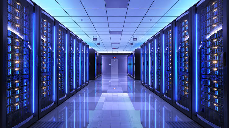 Rows of server racks in a modern data center with blue lighting